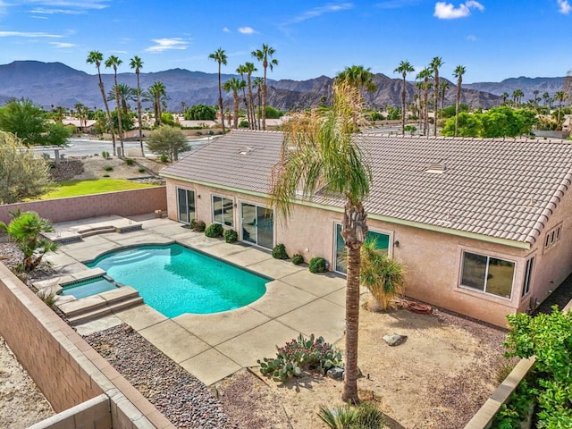 view of swimming pool featuring a mountain view and a patio