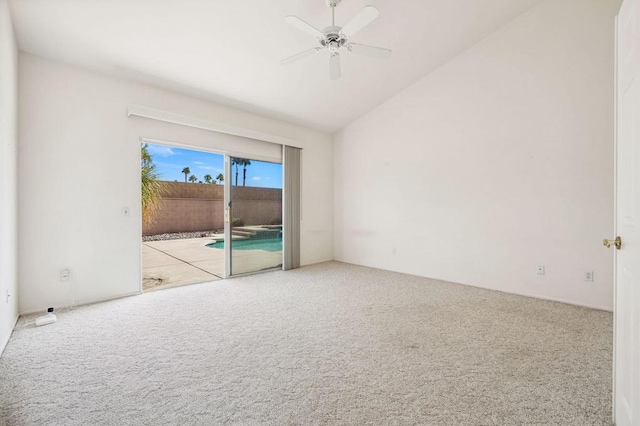 carpeted spare room featuring ceiling fan and lofted ceiling