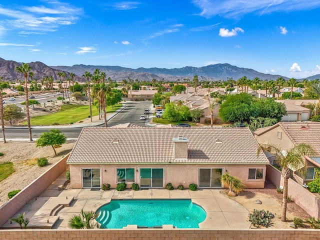 view of swimming pool featuring a patio area and a mountain view