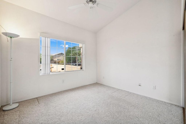 carpeted empty room with ceiling fan and vaulted ceiling