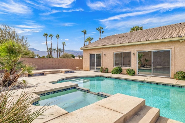 view of swimming pool with an in ground hot tub and a mountain view