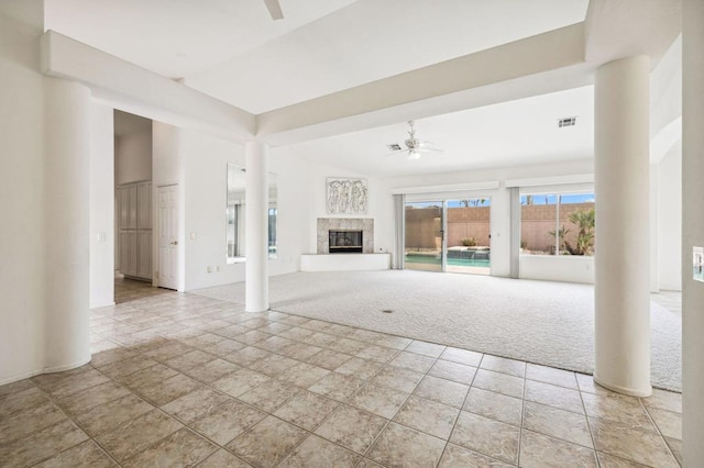 unfurnished living room with light carpet and ceiling fan