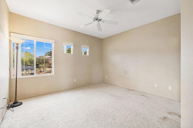 spare room featuring carpet flooring and ceiling fan