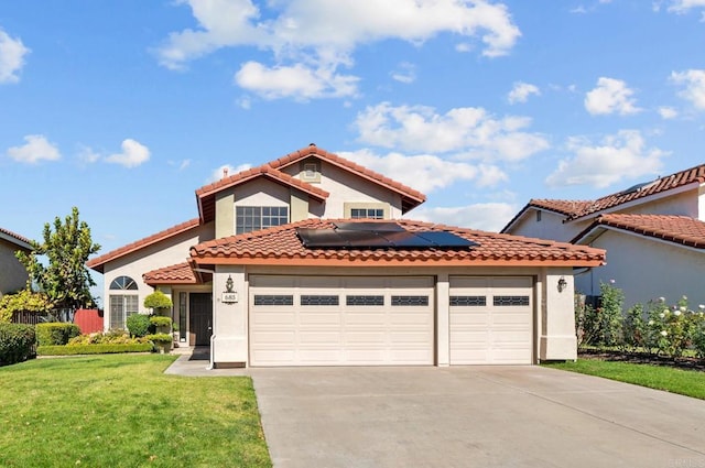 mediterranean / spanish house featuring solar panels and a front yard