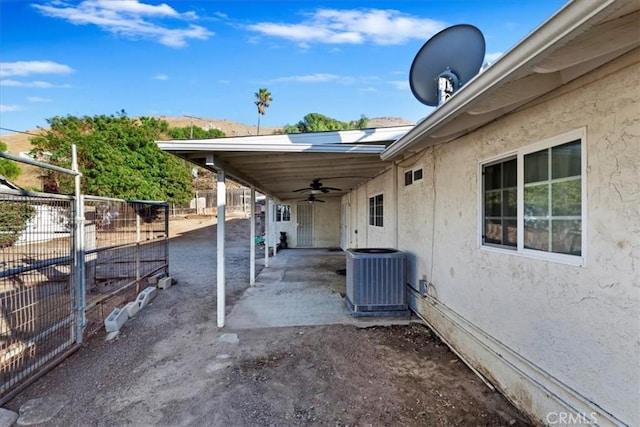 view of patio / terrace with ceiling fan and central AC