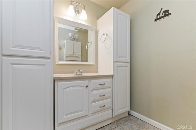 bathroom featuring tile patterned flooring, vanity, and baseboards