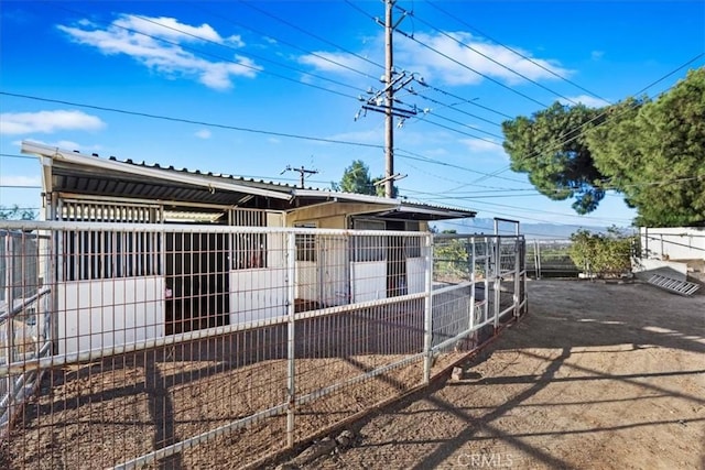 exterior space with metal roof, an outdoor structure, and an exterior structure