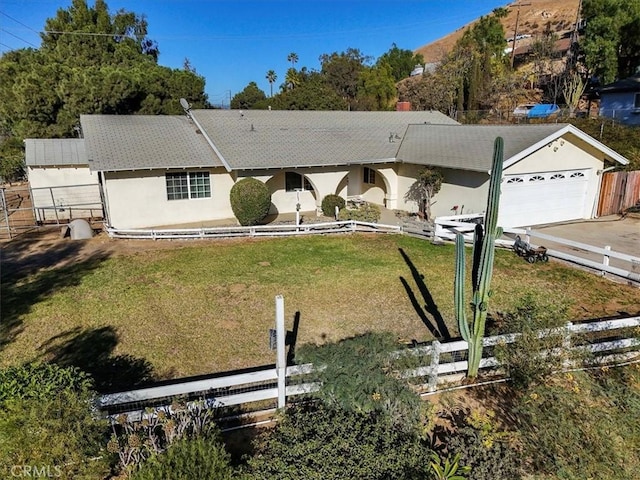 single story home with an attached garage, fence, concrete driveway, and a front yard