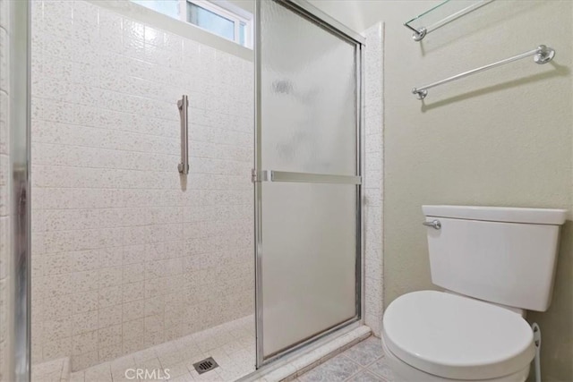 full bathroom with a stall shower and toilet