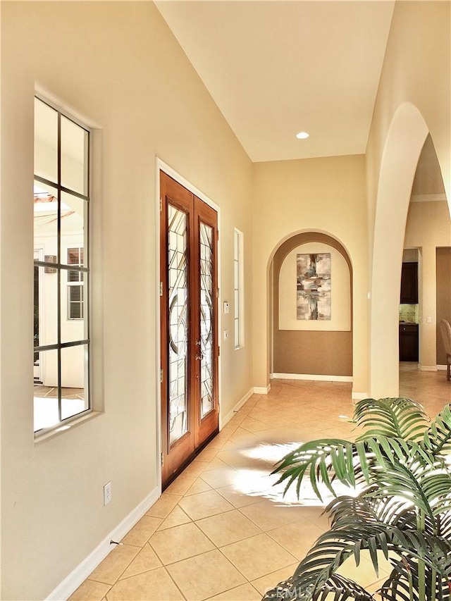 foyer featuring french doors and light tile patterned floors