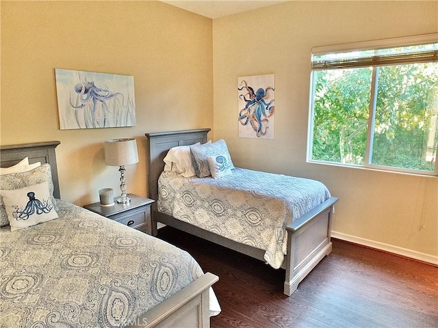 bedroom with dark hardwood / wood-style flooring