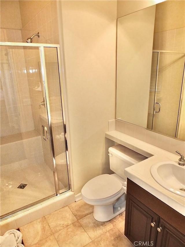 bathroom featuring a shower with door, toilet, tile patterned flooring, and vanity