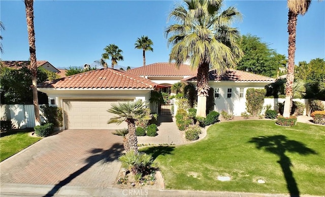 mediterranean / spanish-style house with a garage and a front yard