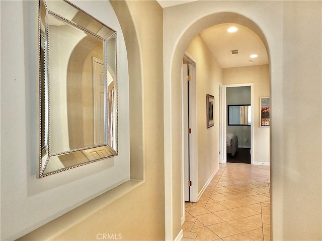 hall featuring light tile patterned floors