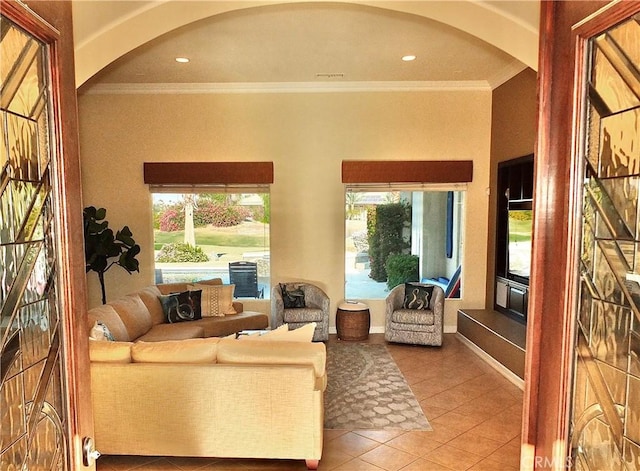 living room with ornamental molding and light tile patterned floors