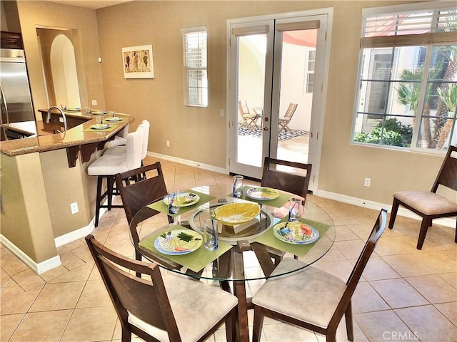 dining area with light tile patterned floors and french doors