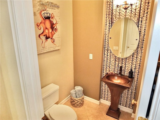 bathroom featuring toilet and tile patterned flooring