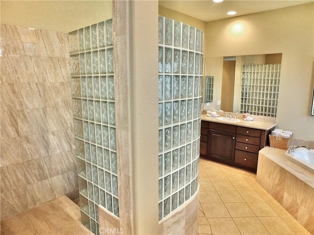 bathroom with tiled shower, tile patterned floors, and vanity