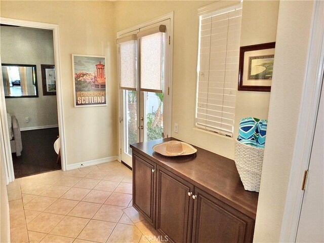 interior space with vanity, french doors, and tile patterned floors