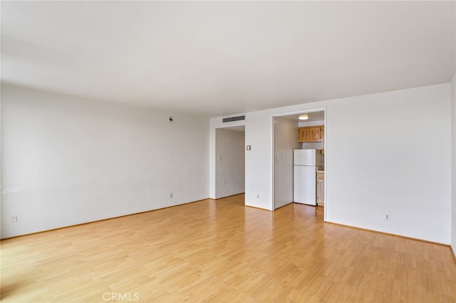 spare room with light hardwood / wood-style floors