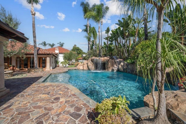 view of pool with pool water feature and a patio