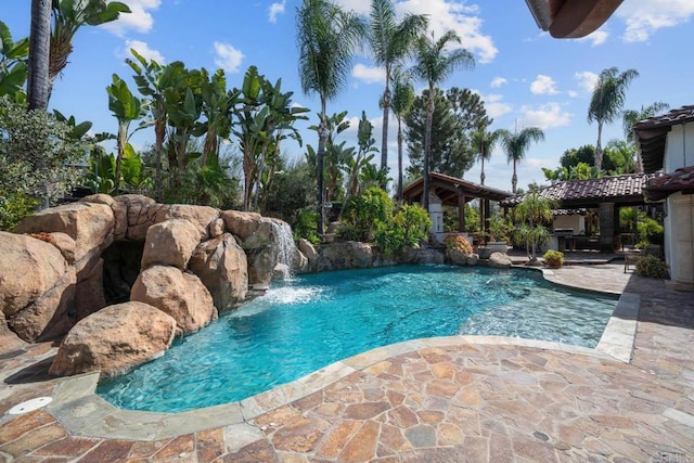 view of pool featuring pool water feature and a patio