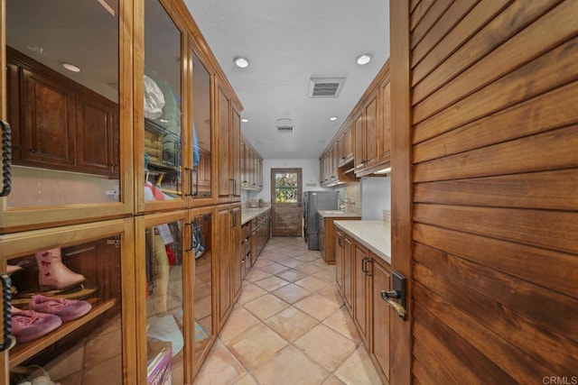 kitchen featuring light tile patterned flooring and fridge