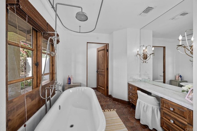 full bathroom featuring toilet, vanity, independent shower and bath, and a notable chandelier