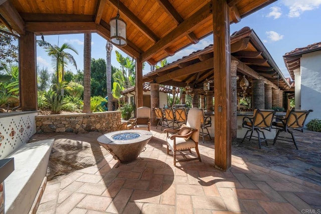 view of patio / terrace with a gazebo, a bar, and an outdoor fire pit