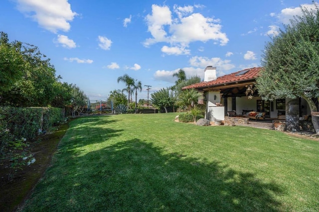 view of yard with ceiling fan, a patio area, and a trampoline