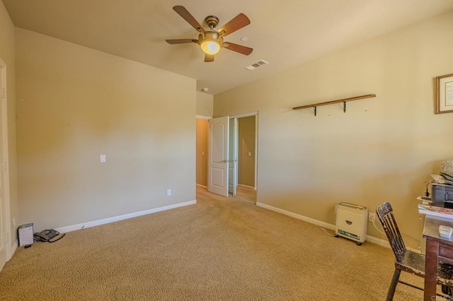 interior space featuring ceiling fan and light colored carpet