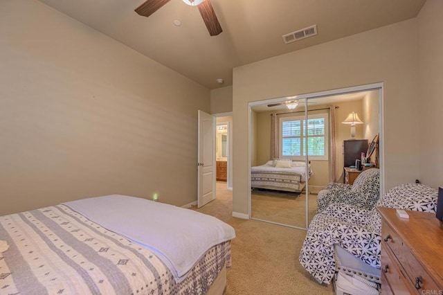 carpeted bedroom featuring ceiling fan, vaulted ceiling, and a closet