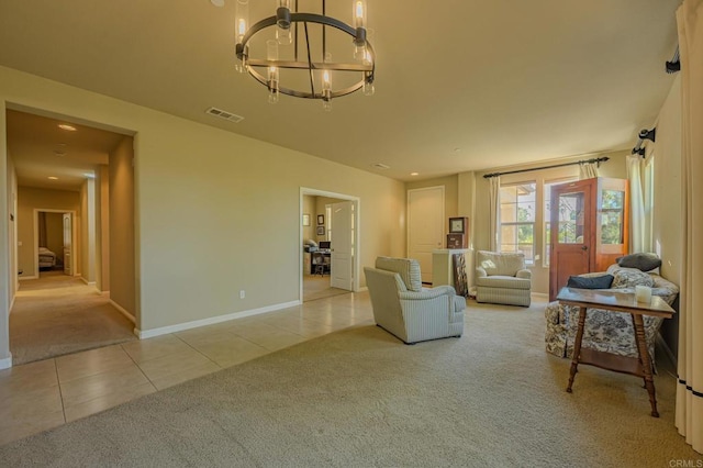 carpeted living room with a chandelier