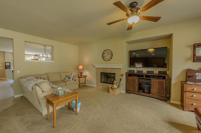 living room with light carpet, a fireplace, and ceiling fan