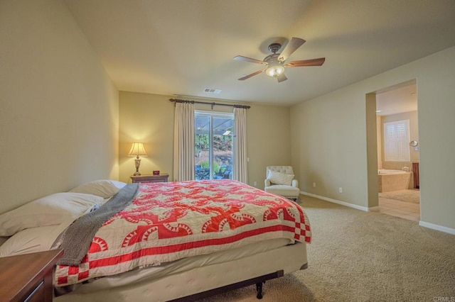 carpeted bedroom with connected bathroom and ceiling fan