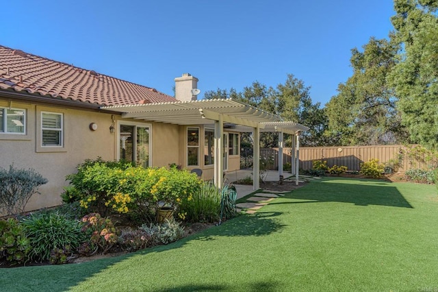 back of property featuring a pergola and a lawn