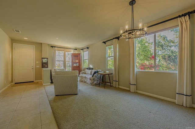 unfurnished living room featuring a notable chandelier and light tile patterned floors