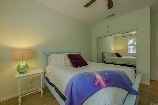 bedroom with a closet, light colored carpet, vaulted ceiling, and ceiling fan