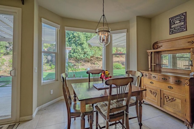 dining area featuring light tile patterned floors and a notable chandelier