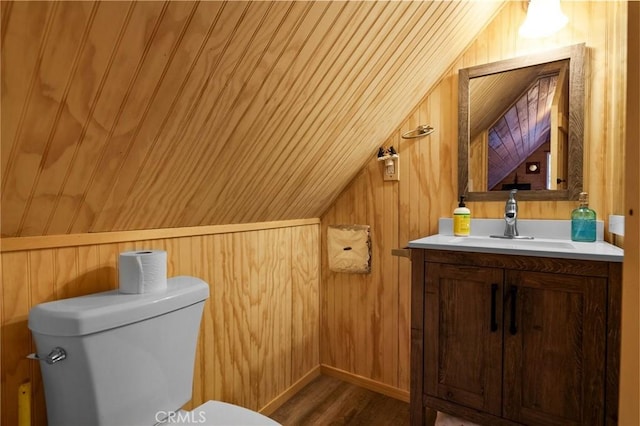 bathroom with wooden ceiling, wood walls, hardwood / wood-style floors, lofted ceiling, and vanity