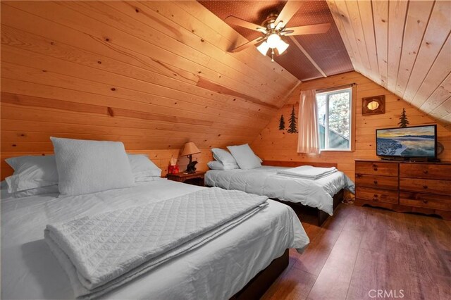 bedroom with ceiling fan, dark wood-type flooring, lofted ceiling, wooden walls, and wood ceiling