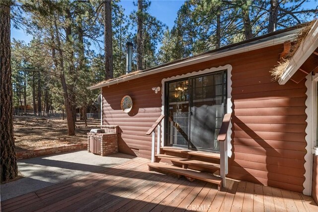 view of exterior entry with a wooden deck