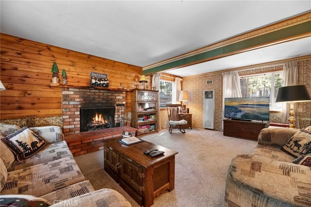 living room with beamed ceiling, light colored carpet, a brick fireplace, and a wealth of natural light