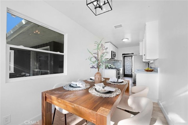 dining area with light wood-type flooring