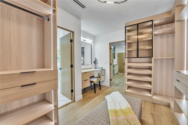 spacious closet featuring light hardwood / wood-style flooring