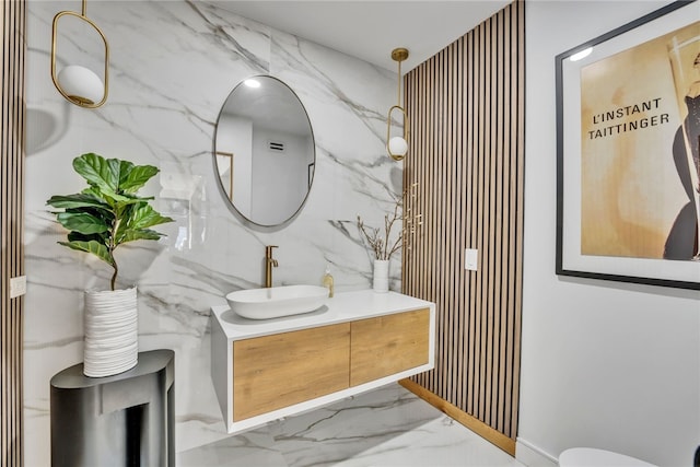 bathroom featuring vanity and tile walls