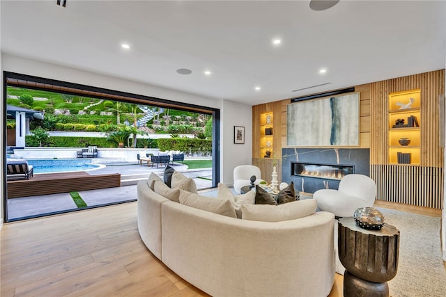 living room with wood walls and light hardwood / wood-style flooring