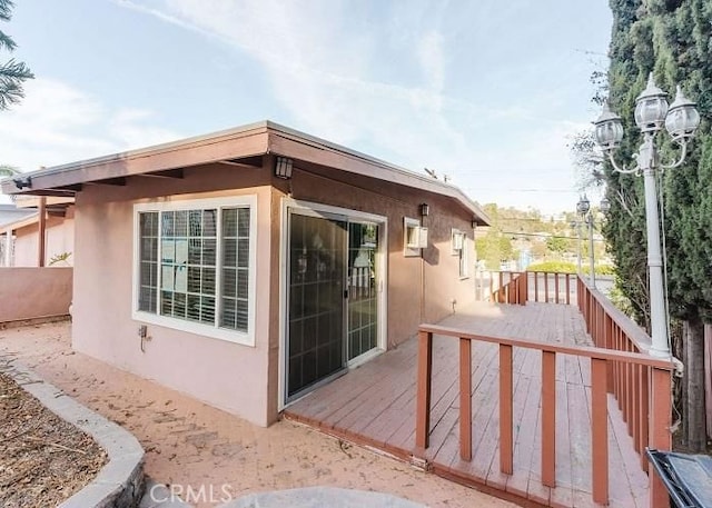 view of property exterior featuring a wooden deck