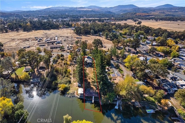 birds eye view of property featuring a water and mountain view