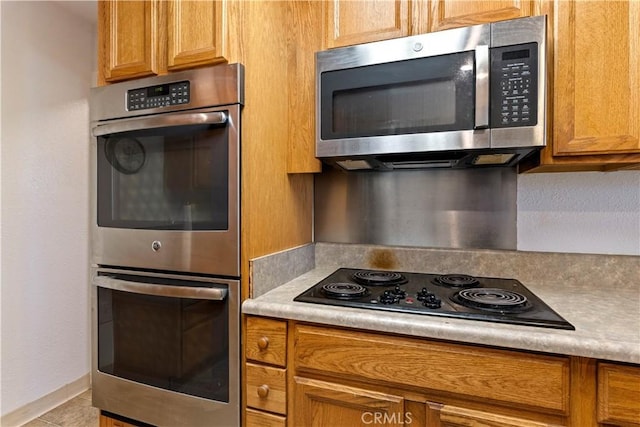 kitchen featuring appliances with stainless steel finishes and light tile patterned floors